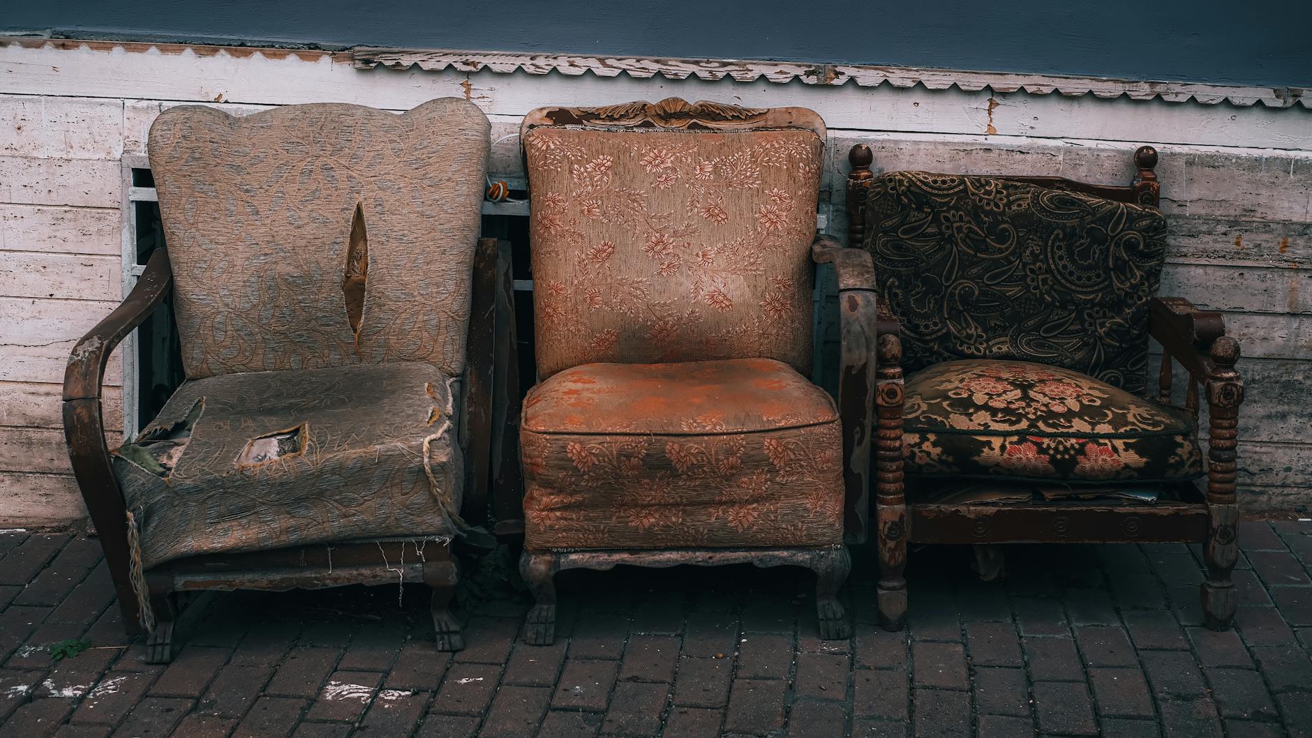 Close-up photo of a French Provincial commode leg showing the distinct 'S' curve of a cabriole leg and a simple hand-carved scallop shell motif on the apron - Antique identification guide