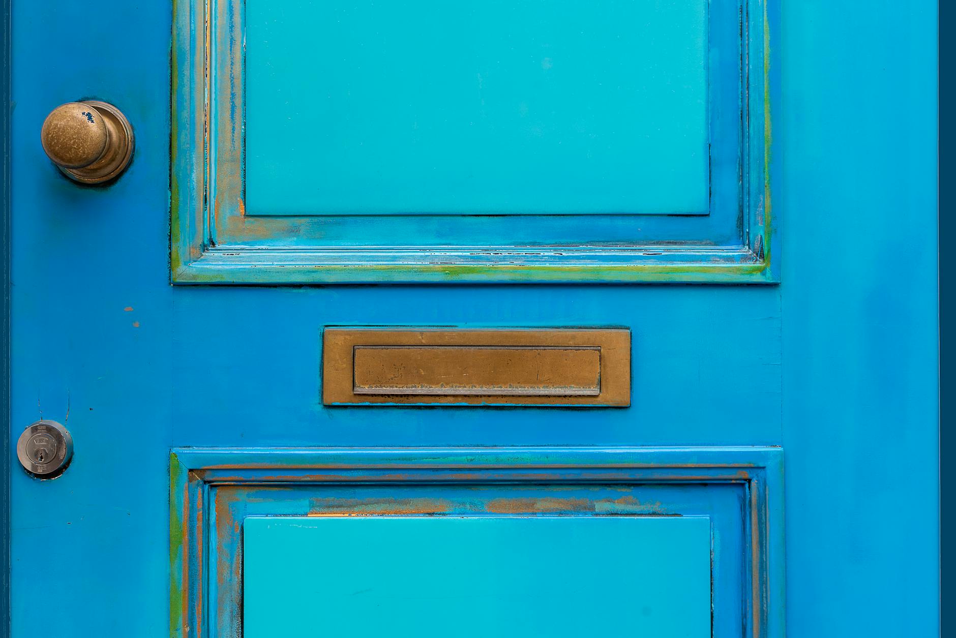 A highly detailed, dark bronze door knob with an Eastlake geometric design, showing natural patina in the crevices - Antique identification guide
