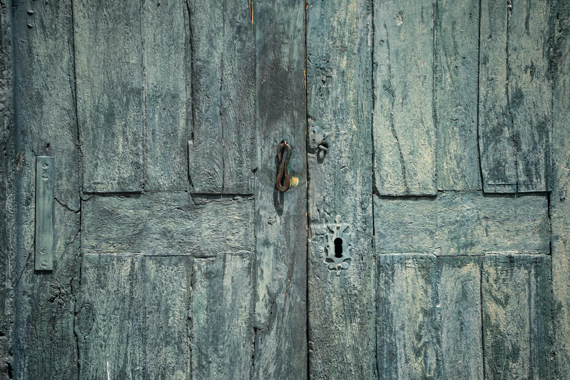 A complete door hardware set laid out on a velvet cloth, including two matching knobs, the connecting spindle, and two decorative backplates - Antique identification guide
