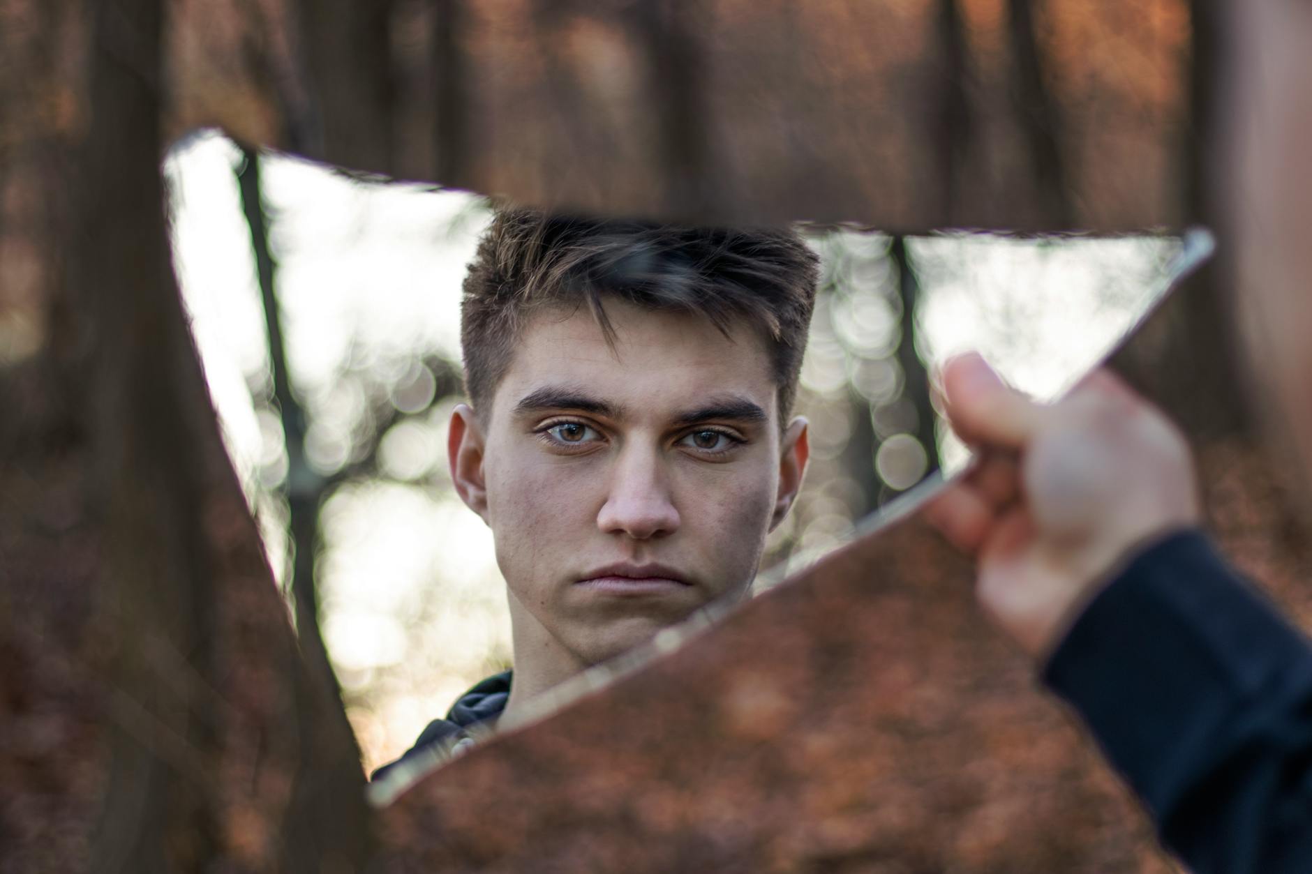 A side-angle photo of an antique mirror reflecting a straight window frame, demonstrating the 'wavy' distortion and ripples inherent in hand-cast or cylinder glass. - Antique identification guide