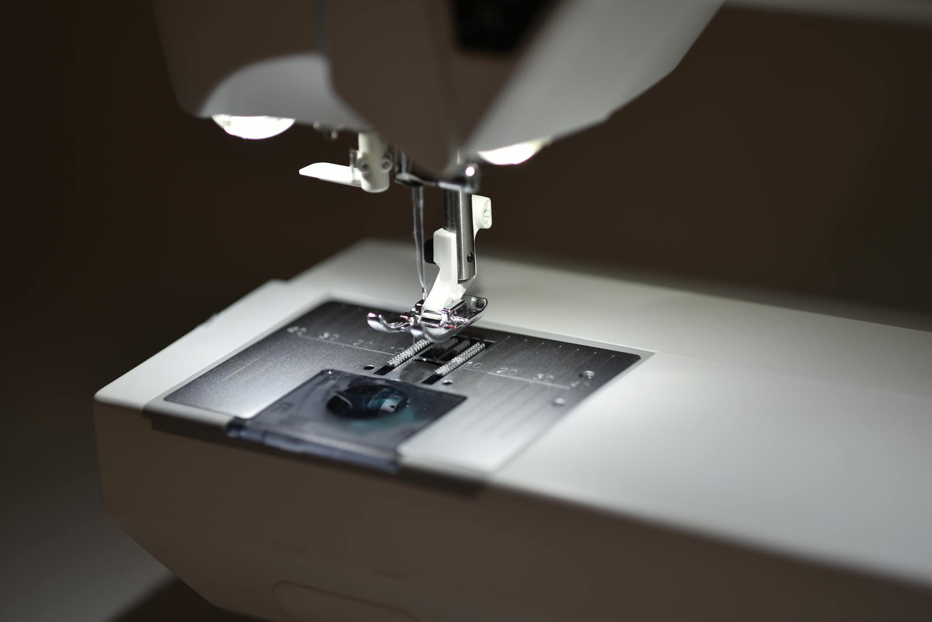 A vintage sewing machine with the name 'Minnesota' clearly painted in gold script on the arm, sitting on a wooden table - Antique identification guide
