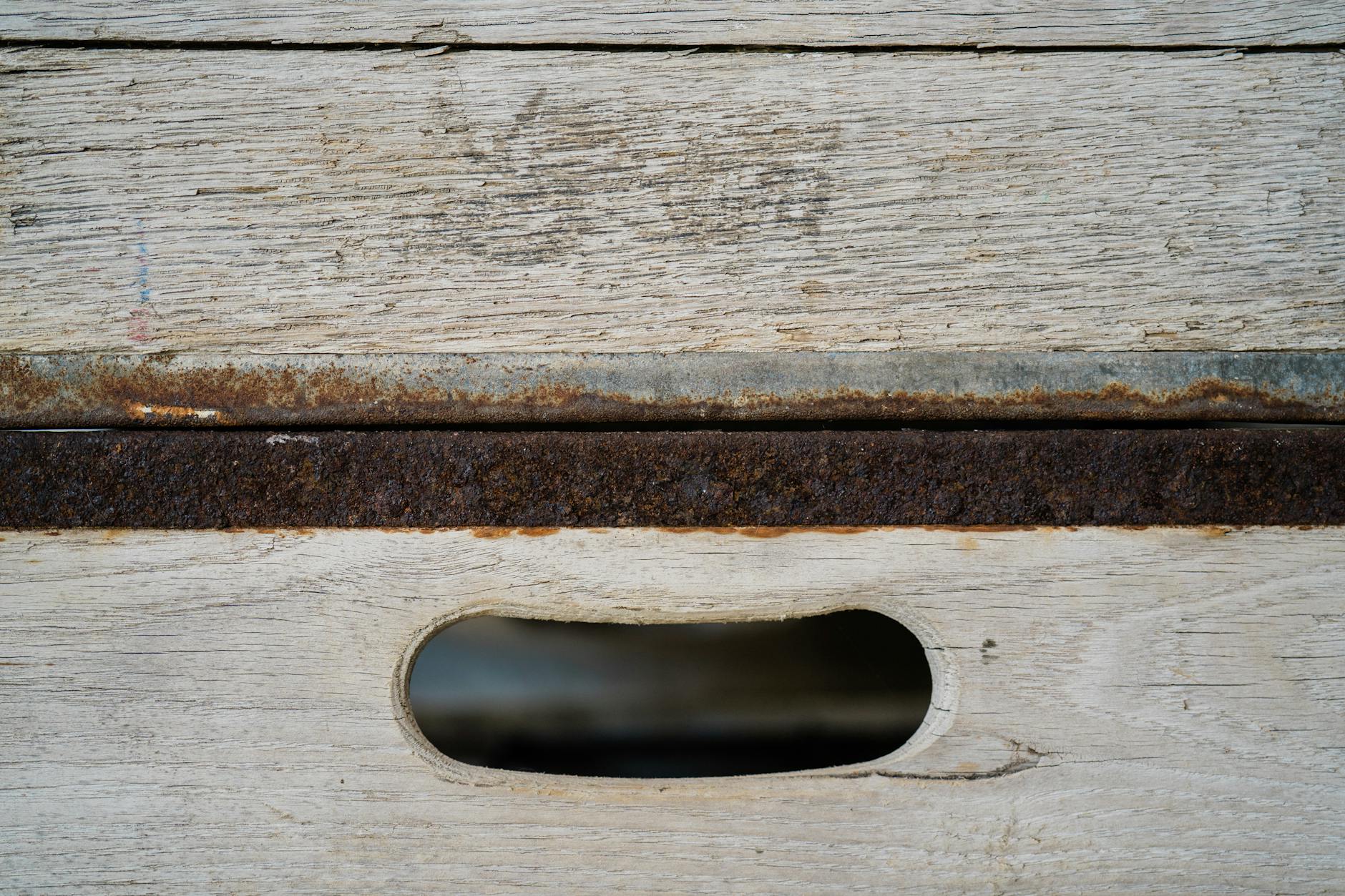 Macro shot of a chipped section of an ornate frame revealing the white, chalky gesso layer beneath the gold surface and the wood substrate underneath that. - Antique identification guide
