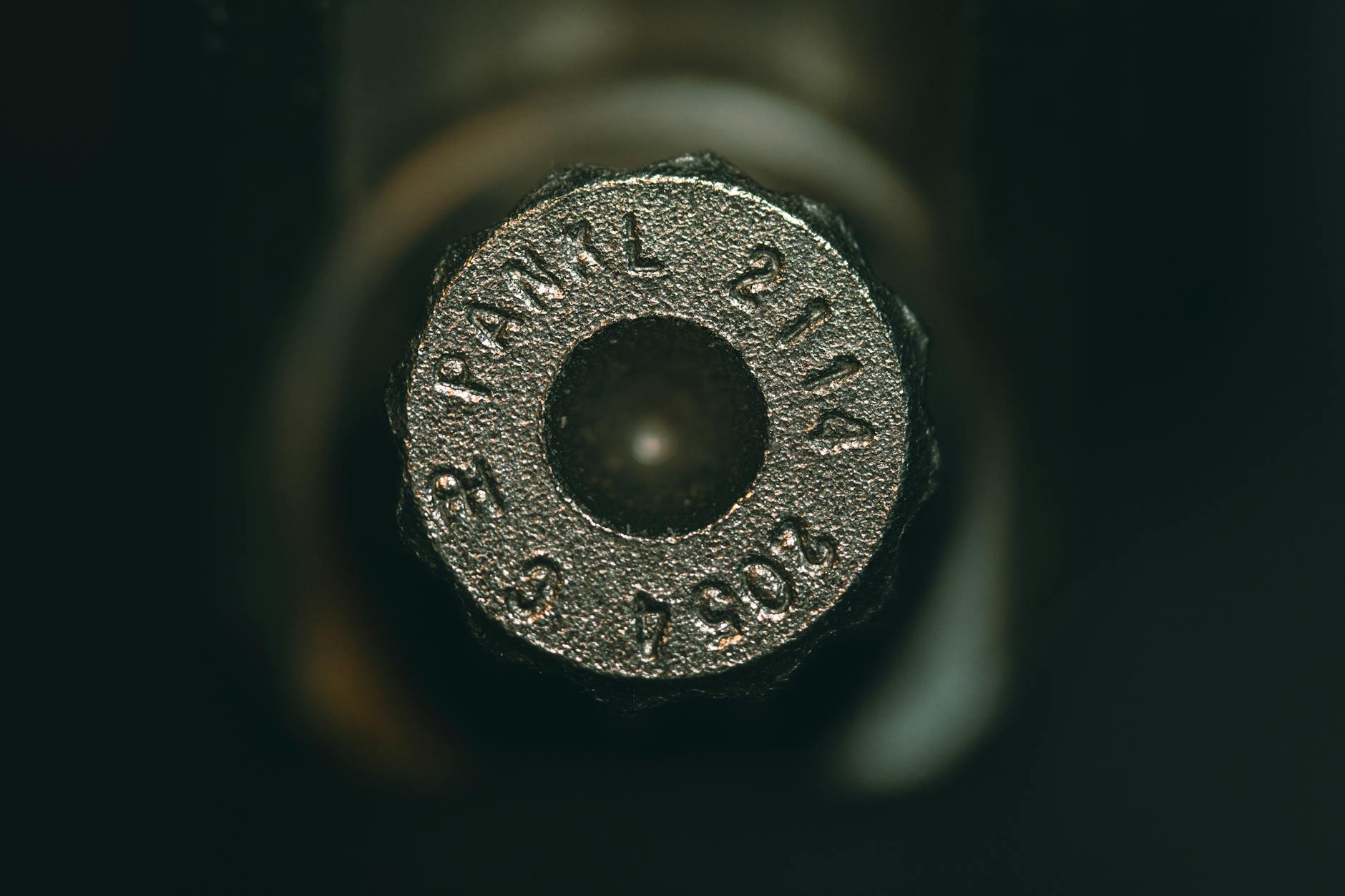 An appraiser using a magnifying loupe to examine the matching serial numbers on the bottom of a revolver frame - Antique identification guide