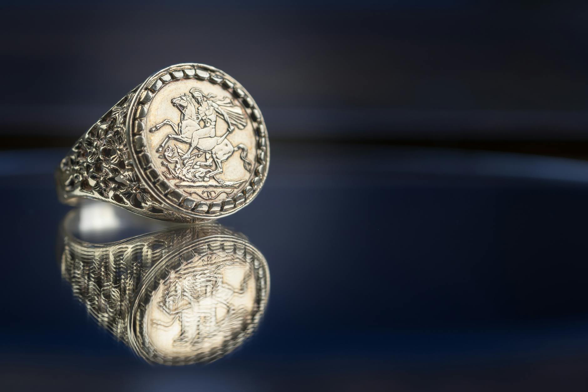 A professional appraiser carefully applying a drop of red testing acid from a glass dropper onto a filed notch on the base of a silver candlestick - Antique identification guide